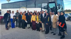 VSC team and clients standing outside infront of a large bus