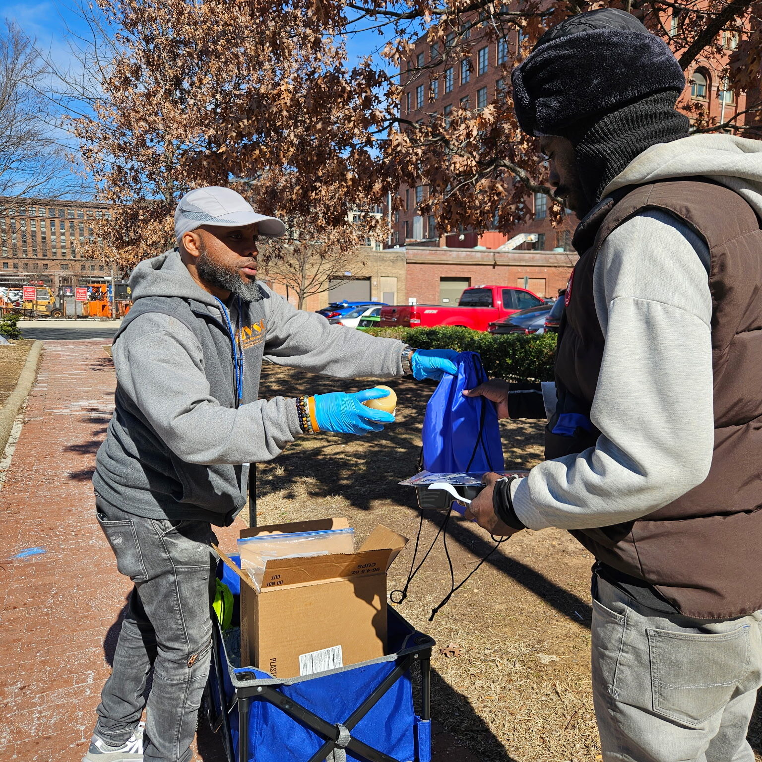 VSC First Responder Services staff distributing meals on the ground
