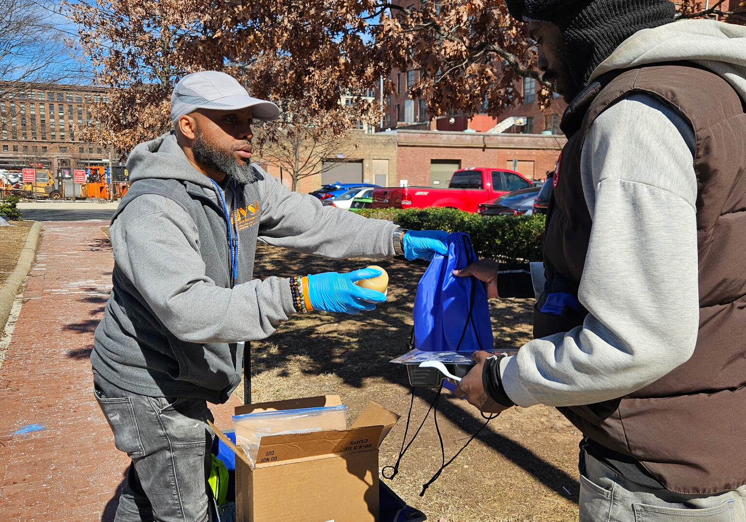 VSC First Responder Services staff distributing meals on the ground